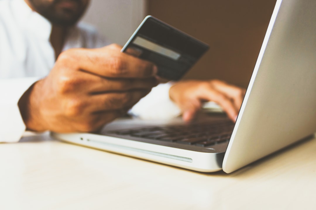 Paying by card on a laptop, weighing CCRN course cost against AACN's published exam and renewal fees