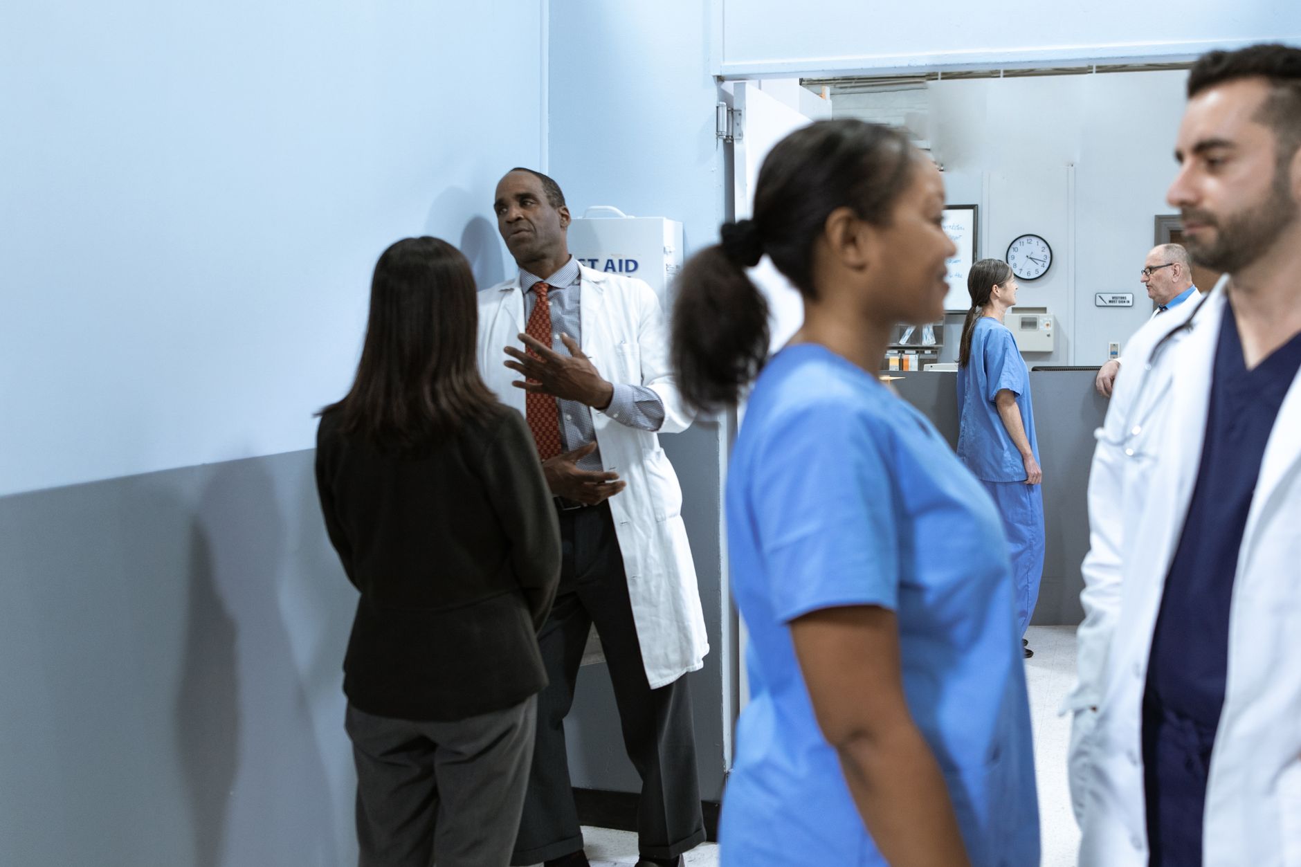 Registered nurse delegating a routine task to a nursing assistant on a med-surg unit