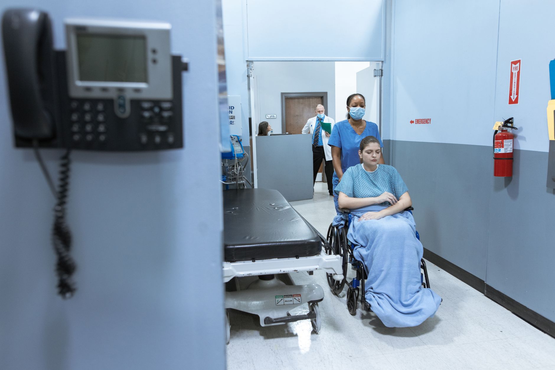 Nurse and unlicensed assistive personnel coordinating patient care during a shift