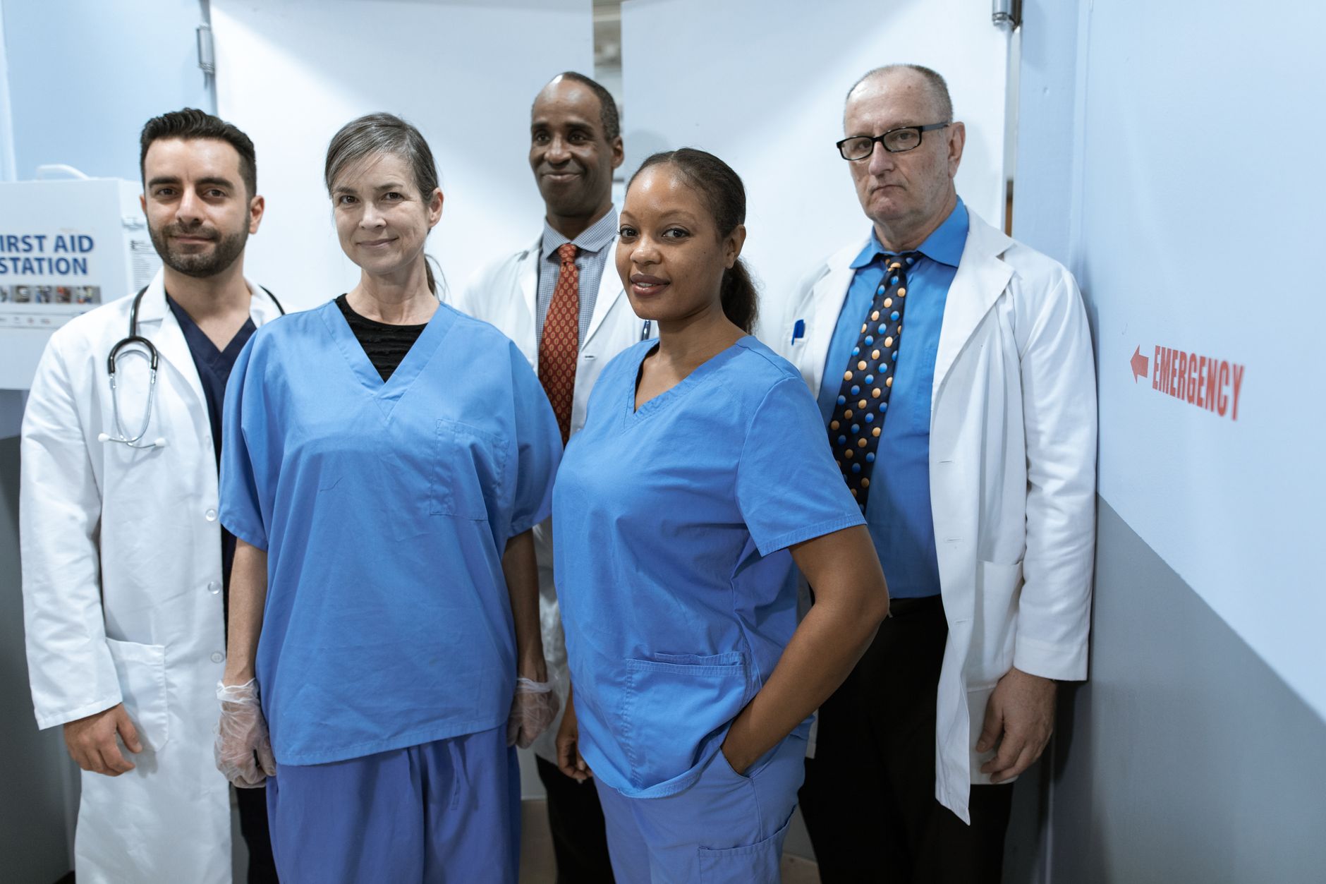 Emergency department team of nurses and physicians coordinating care during a busy shift