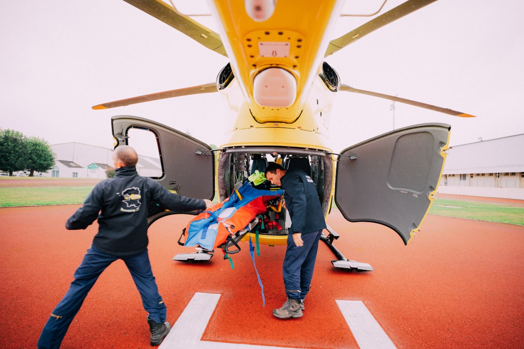 Flight nurse and medevac crew loading a patient into a medical helicopter