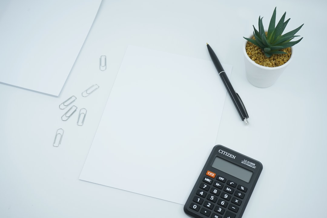 Basic four-function calculator and HESI A2 math worksheet on a desk