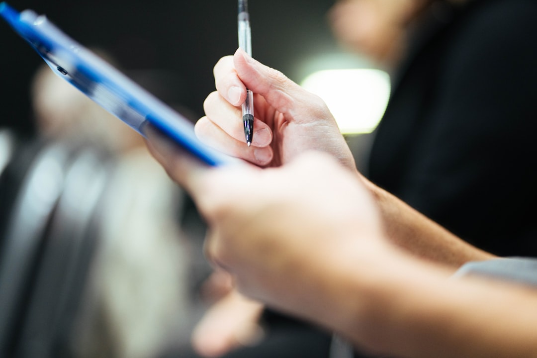 Nurse documenting physical assessment findings in a patient chart