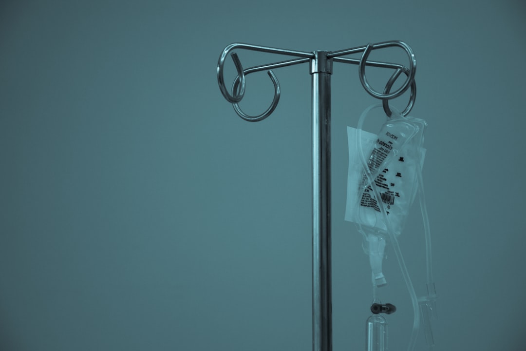 Nurse managing an IV and monitor for a medical-surgical patient