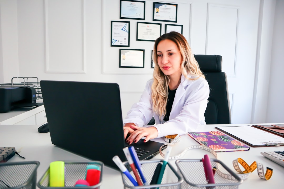 Nurse reviewing multistate nursing license requirements on a laptop