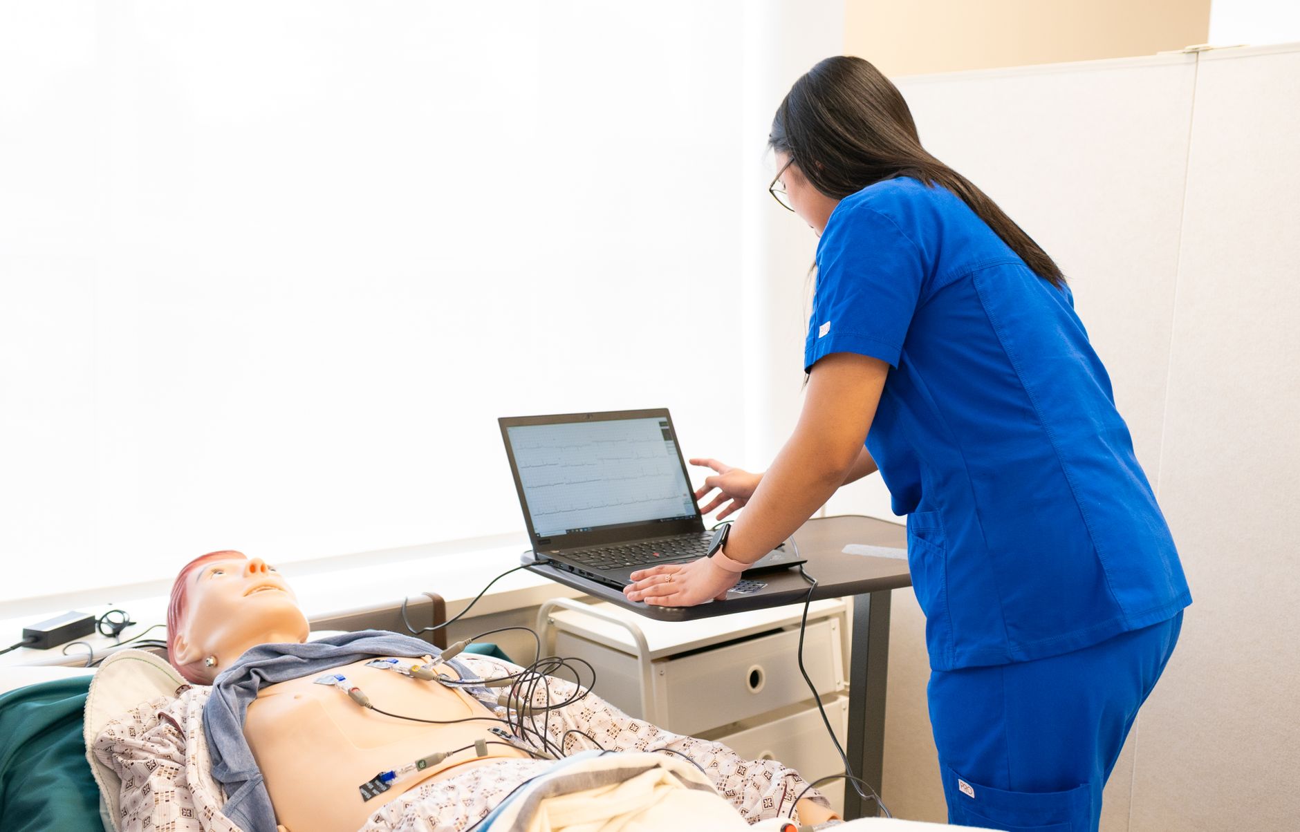 Nursing student practicing NGN clinical-judgment case study questions on a laptop