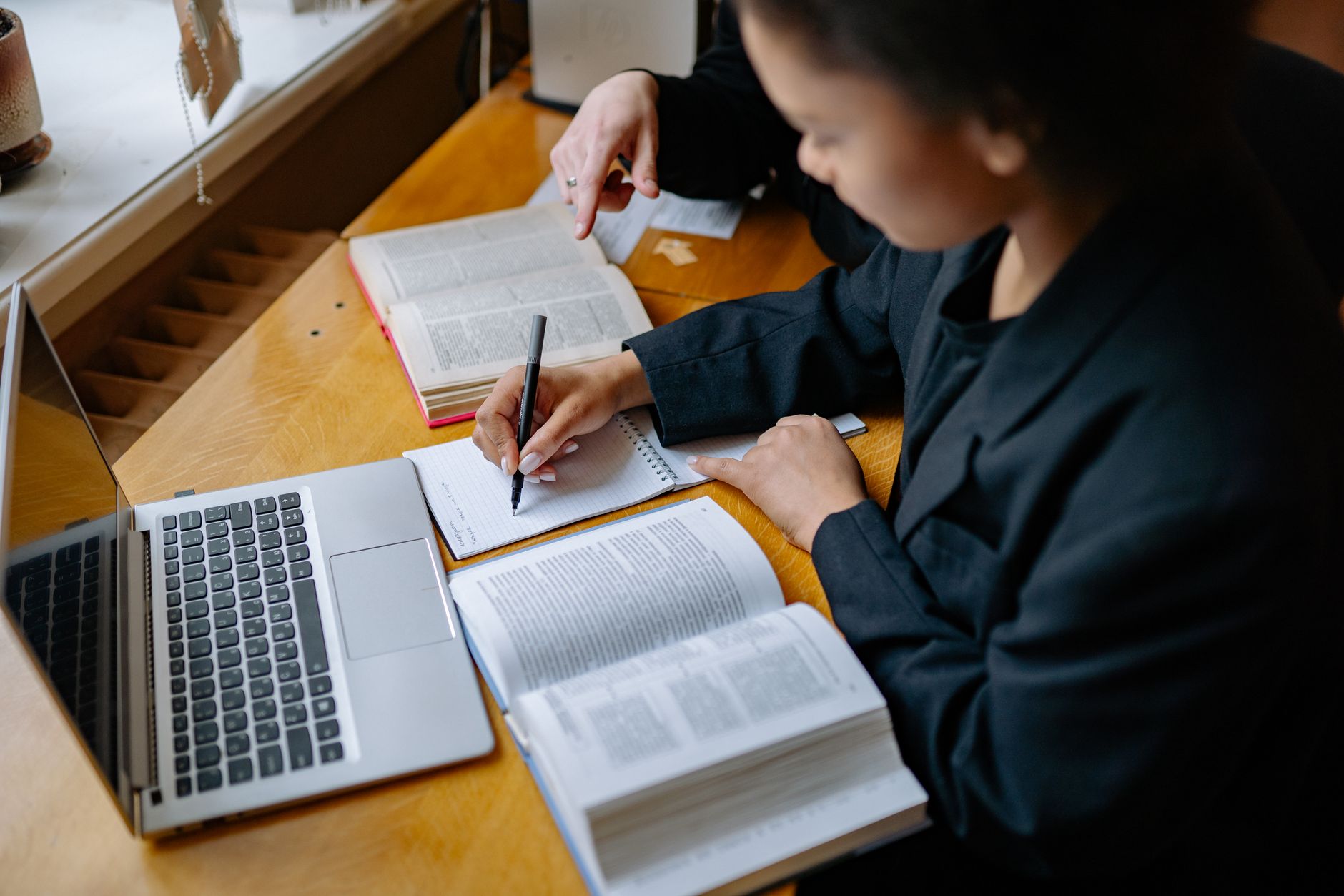 Nursing student working through NCLEX-style preview questions with rationales on a laptop