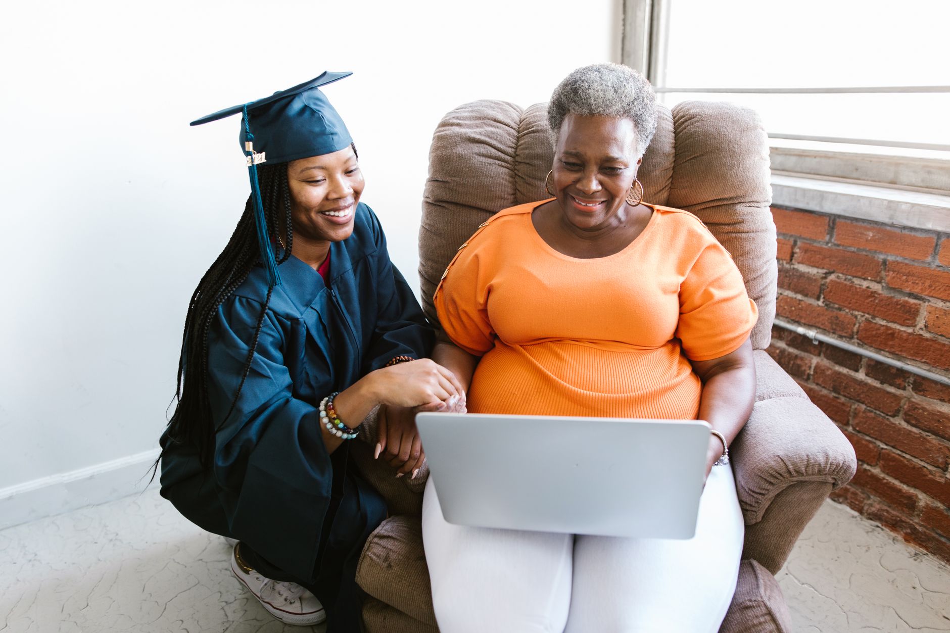 A relieved nursing graduate viewing official NCLEX Quick Results on a laptop two days after the exam