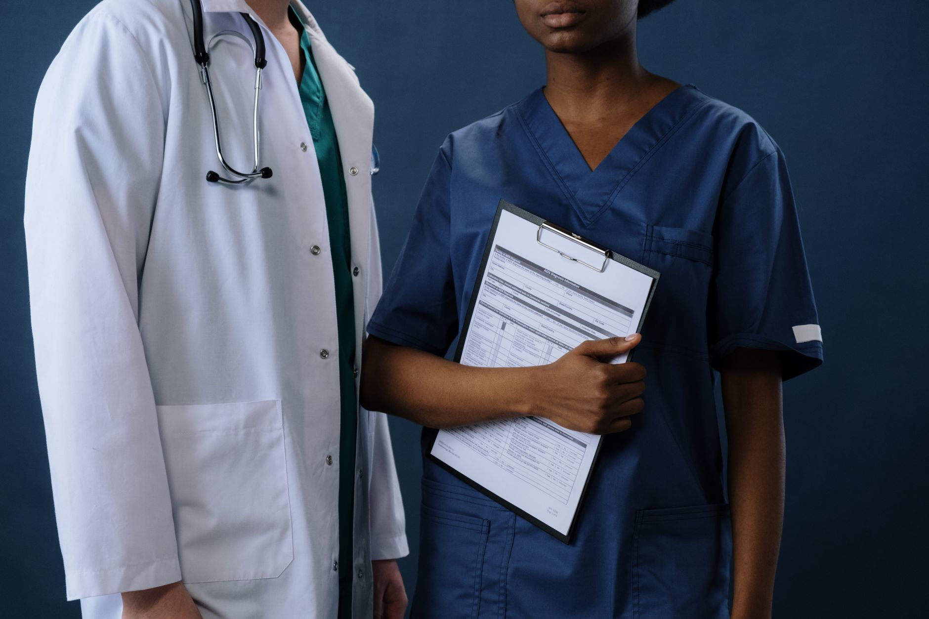 Nurse reading a patient’s lab results on the chart during rounds