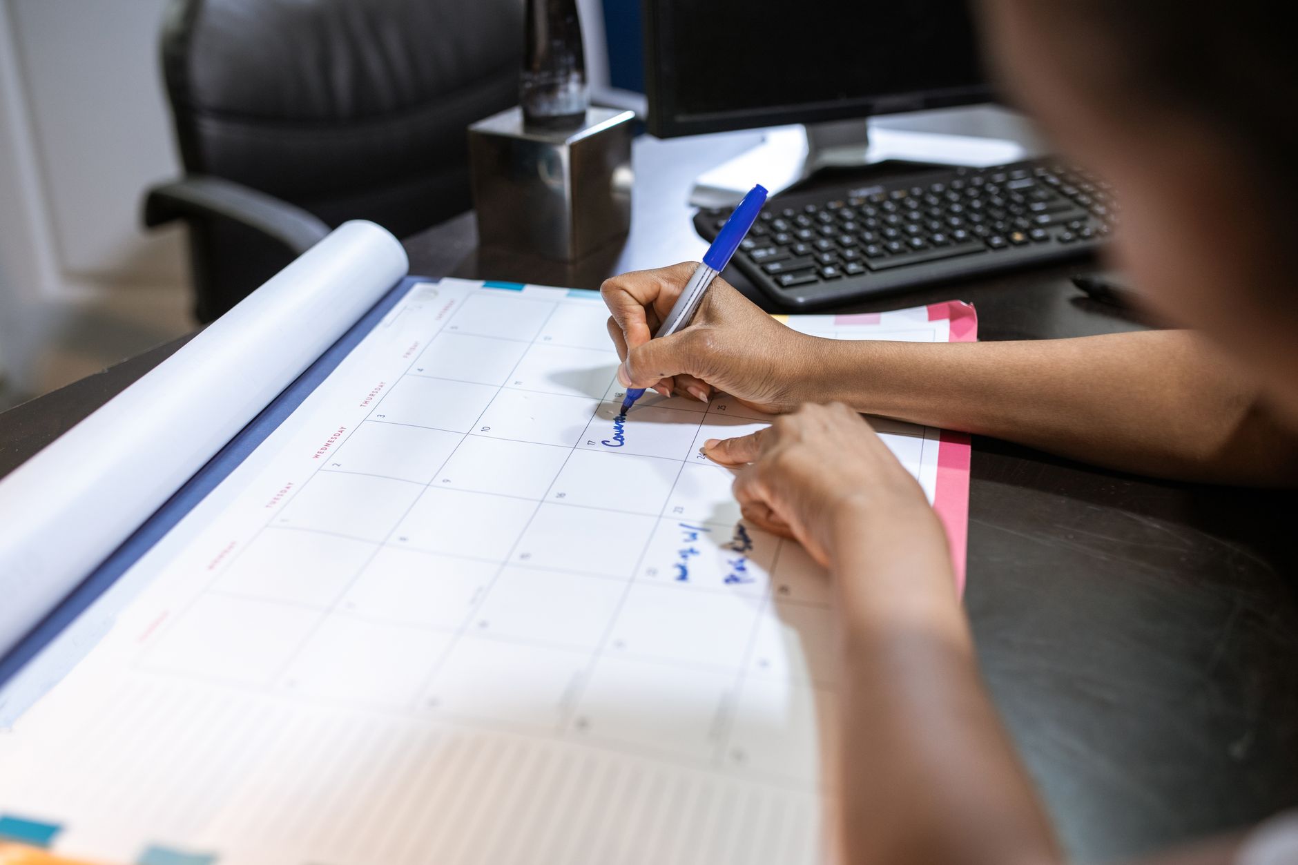 A nursing student tracking scholarship deadlines and award amounts on a calendar and spreadsheet