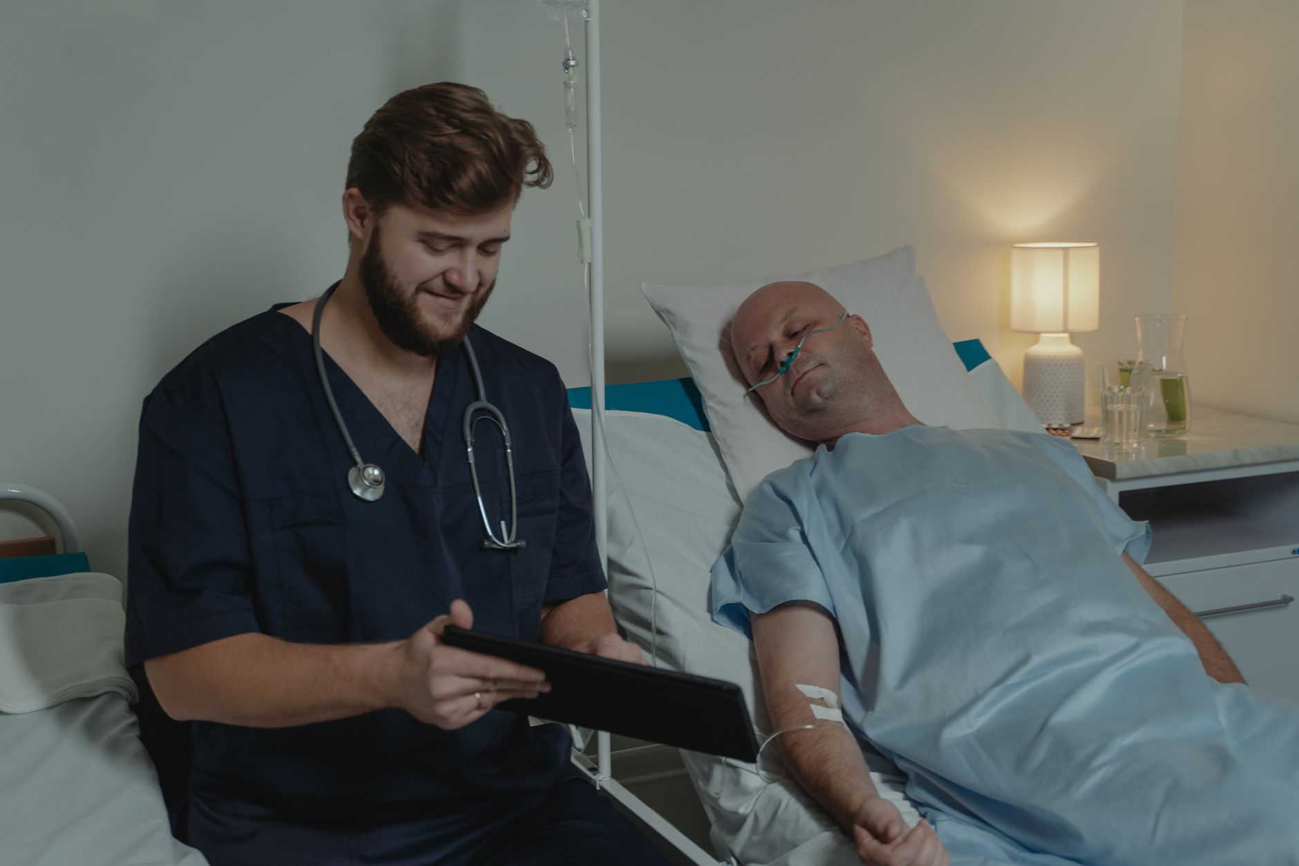 Progressive care nurse monitoring a telemetry patient at the bedside