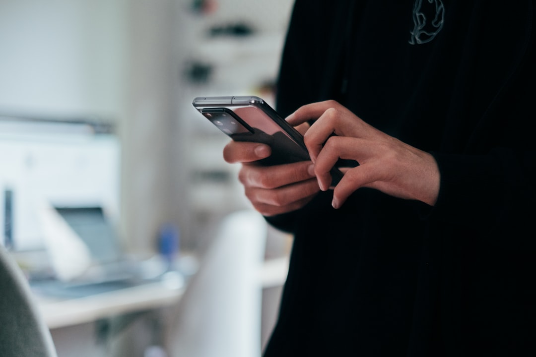 Candidate checking NCLEX results on a phone after testing
