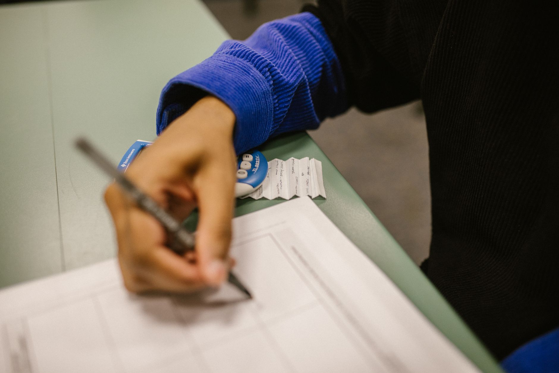 A student reviewing a wrong practice-test answer and writing down why they missed it