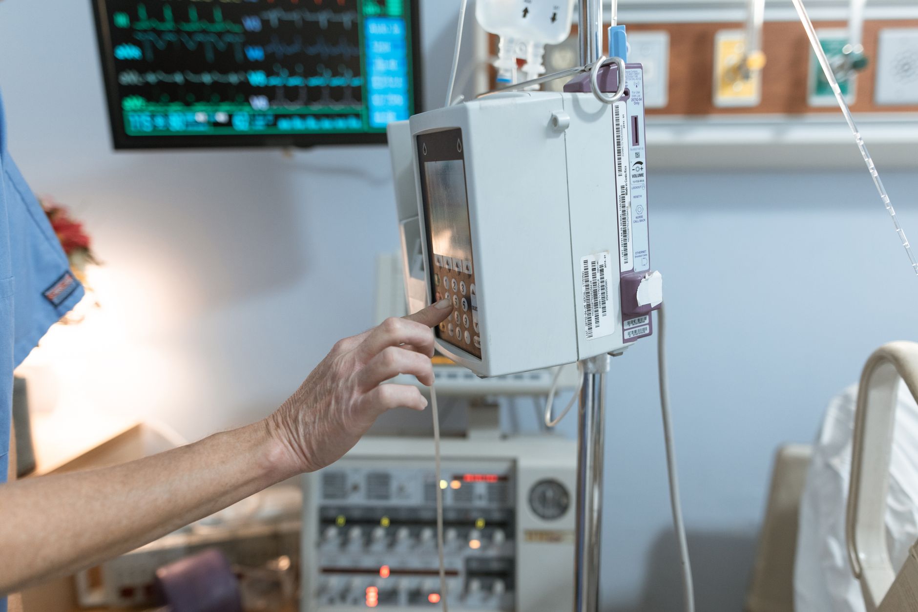Nurse scanning multiple patient monitors to decide who needs care first on a busy shift