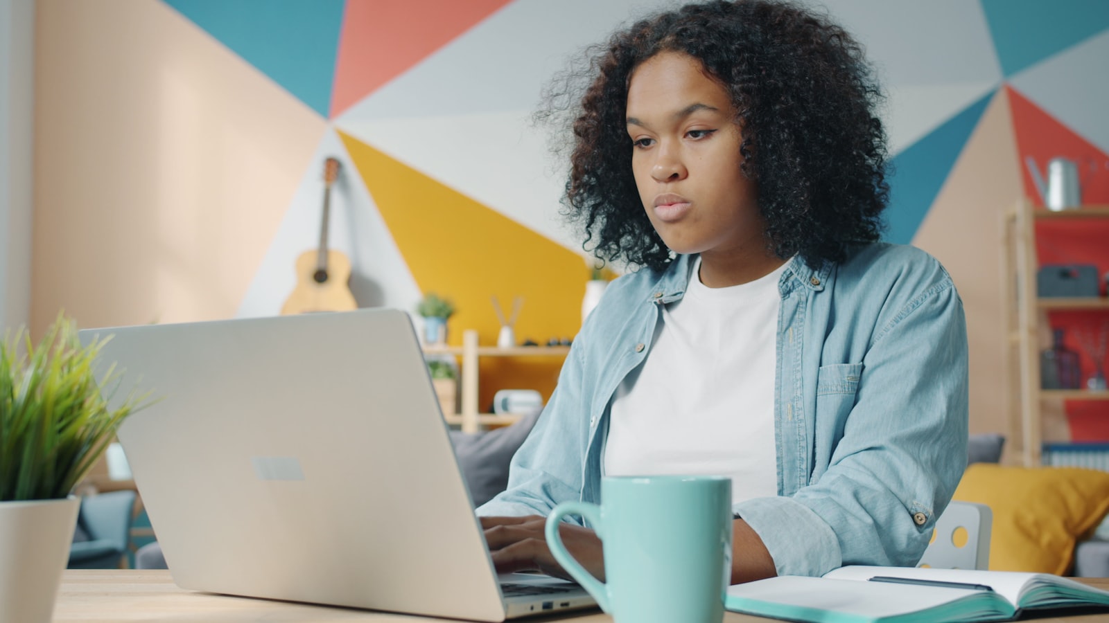 Prospective nursing student researching credentials on a laptop, sorting out which of RN, BSN, LPN and CNA is a licence and which is a degree