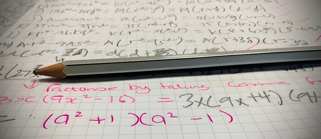 Nursing student working TEAS math problems by hand on scratch paper