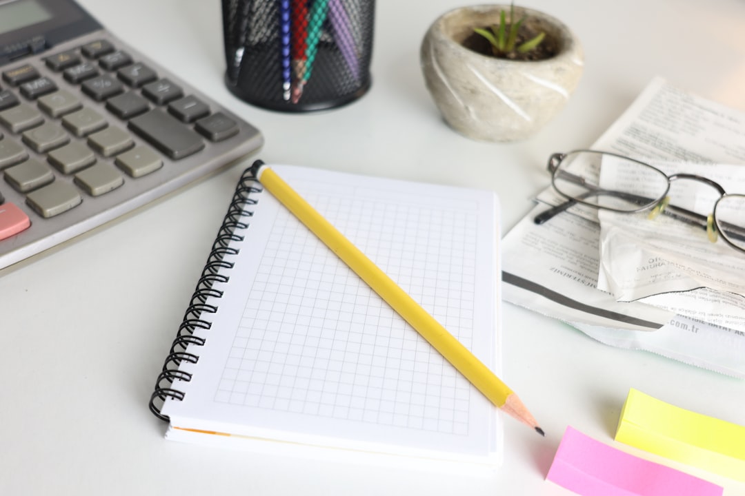 Basic four-function calculator beside a notebook of TEAS math practice