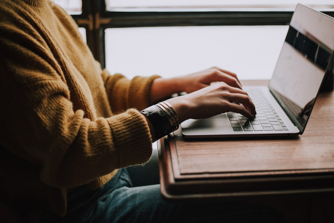 A pre-nursing student checking individual nursing program TEAS score requirements on a laptop