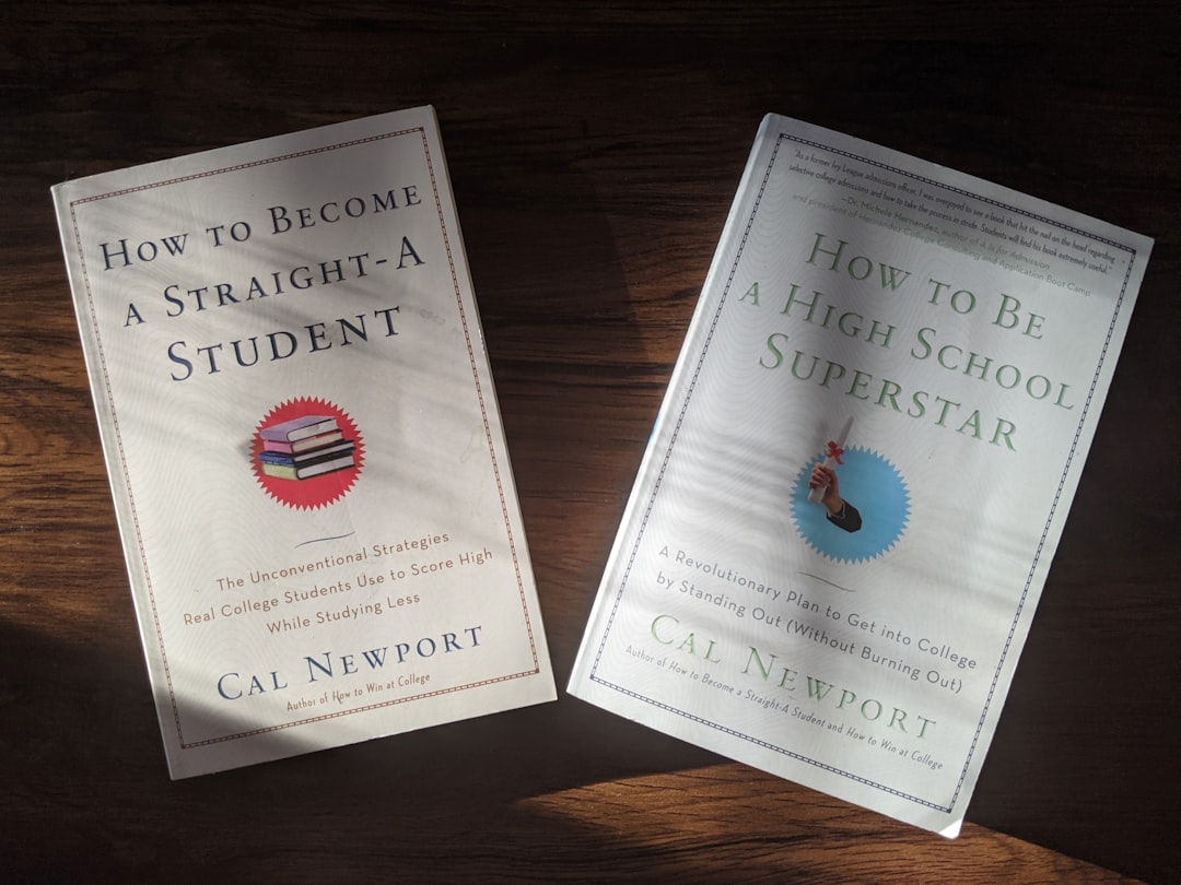 A pre-nursing student comparing TEAS and HESI A2 study guides side by side at a desk