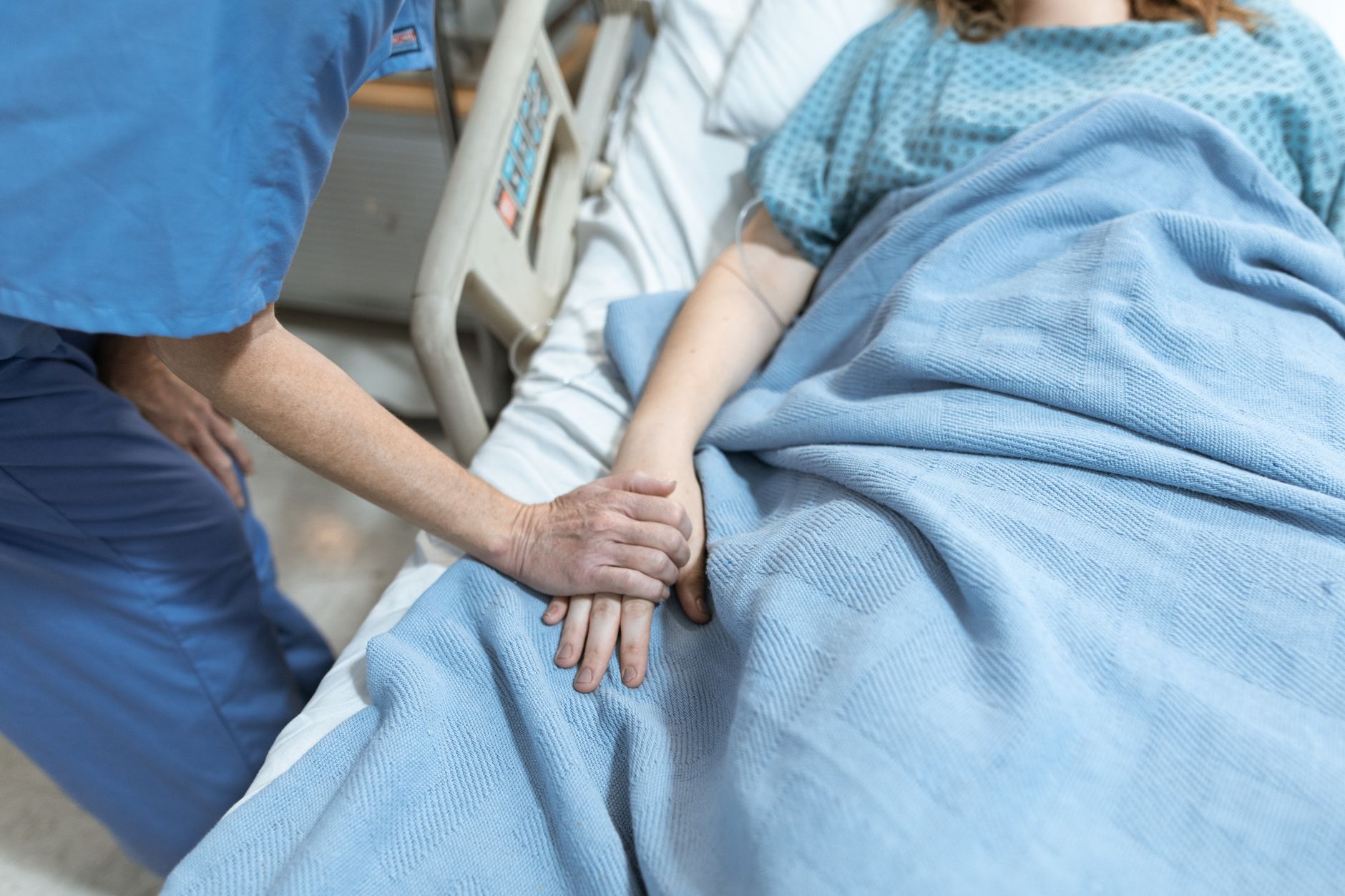 Telemetry nurse assessing a cardiac patient at the bedside